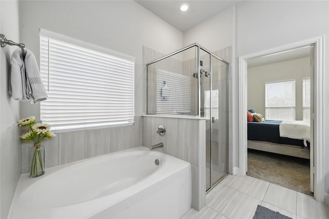 full bath featuring a garden tub, a stall shower, tile patterned floors, and plenty of natural light