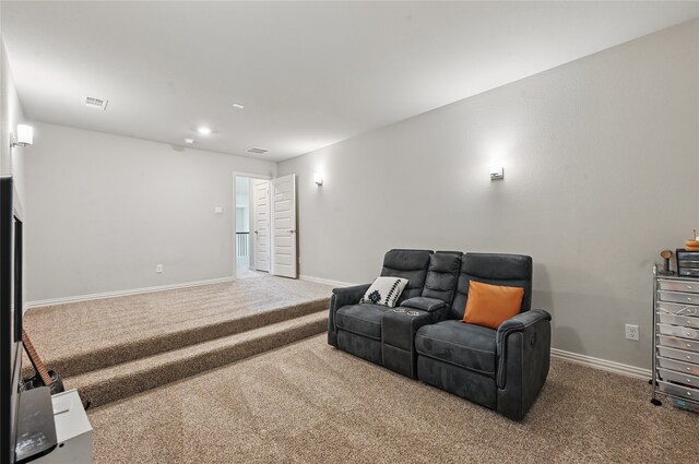 bedroom featuring lofted ceiling, light colored carpet, visible vents, and baseboards
