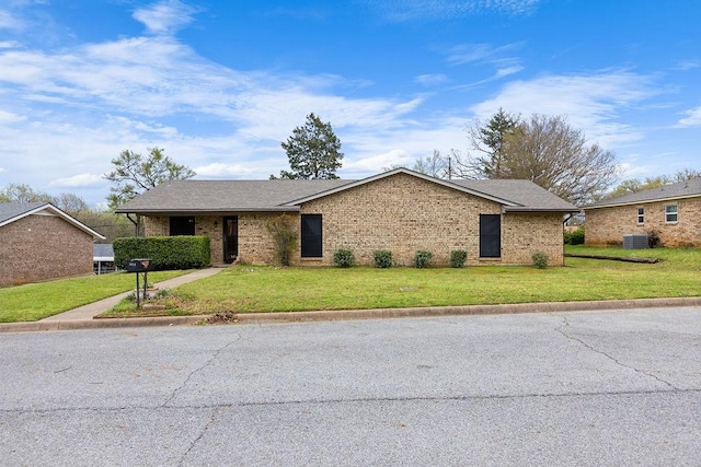 3014 Jennifer Ave, Denison, TX 75020 - view of front of property with brick siding, central air condition unit, and a front lawn