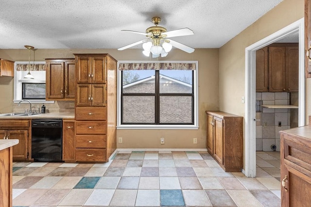 3014 Jennifer Ave, Denison, TX 75020 - kitchen featuring brown cabinetry, dishwasher, a sink, and light countertops