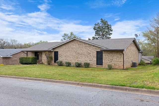 3014 Jennifer Ave, Denison, TX 75020 - view of front of home with cooling unit, a shingled roof, a front yard, and brick siding