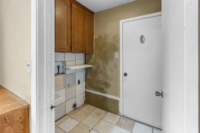 3014 Jennifer Ave, Denison, TX 75020 - interior space with tile patterned floors, tasteful backsplash, and a textured ceiling