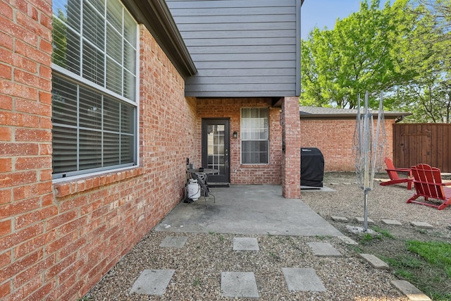 view of patio with a grill and fence