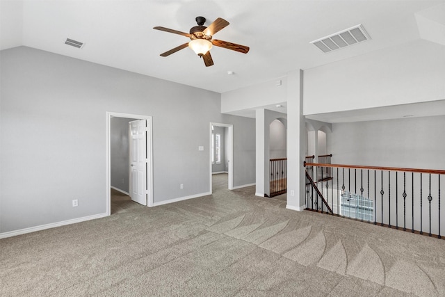 unfurnished room featuring carpet, visible vents, baseboards, and a ceiling fan