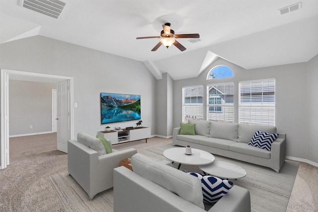 living area featuring visible vents, ceiling fan, baseboards, and lofted ceiling
