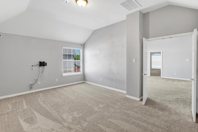 interior space featuring visible vents, baseboards, lofted ceiling, and a wealth of natural light