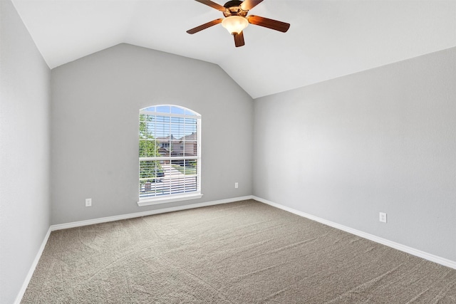 carpeted empty room featuring baseboards, a ceiling fan, and lofted ceiling