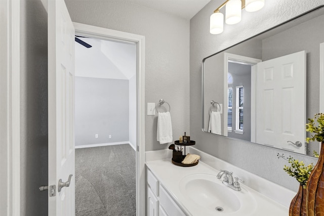 bathroom with vanity and a textured wall