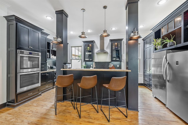 kitchen featuring open shelves, wall chimney exhaust hood, stainless steel appliances, and ornamental molding
