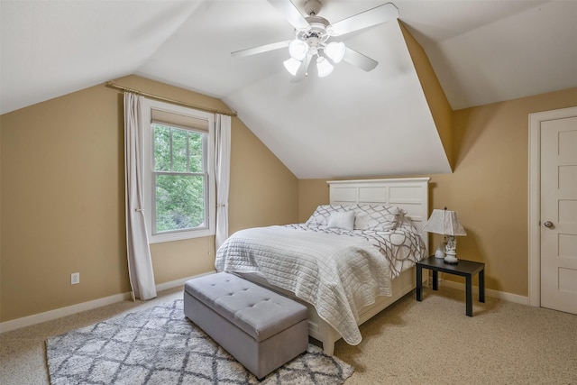 carpeted bedroom with vaulted ceiling, baseboards, and ceiling fan