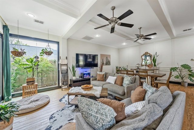 living room featuring visible vents, crown molding, and beam ceiling