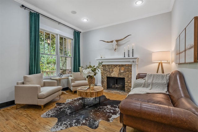 living area featuring a stone fireplace, wood finished floors, recessed lighting, and ornamental molding