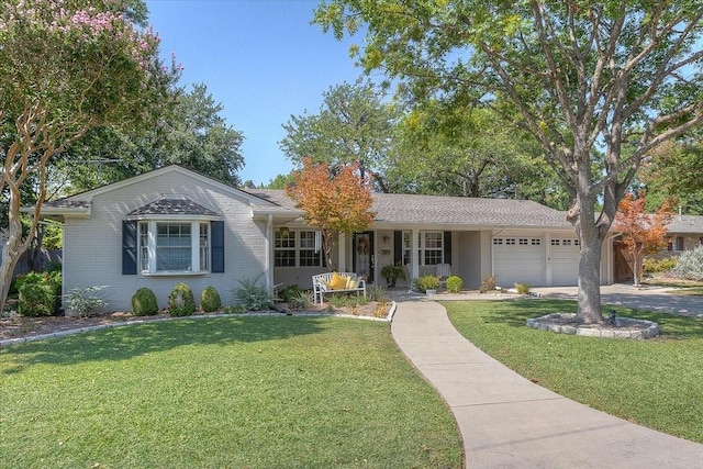 ranch-style house featuring an attached garage, a front yard, and driveway