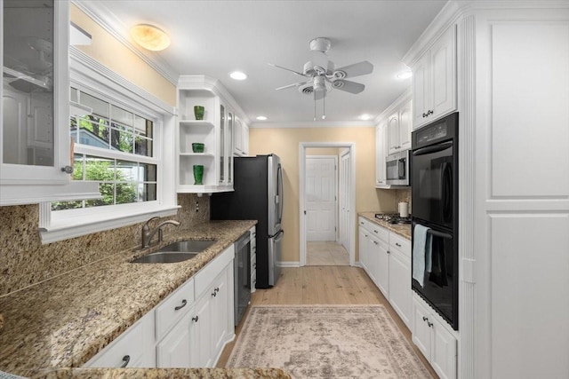 kitchen featuring appliances with stainless steel finishes, a sink, white cabinetry, ceiling fan, and open shelves