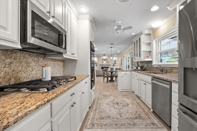 kitchen featuring stainless steel appliances, ceiling fan, tasteful backsplash, white cabinets, and recessed lighting