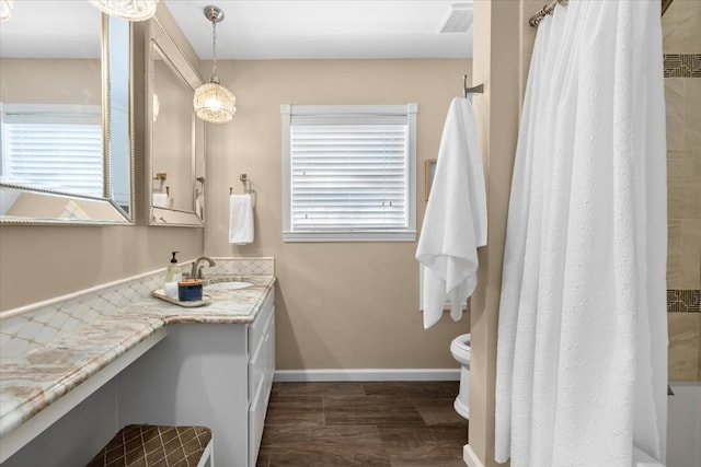 full bathroom with toilet and vanity