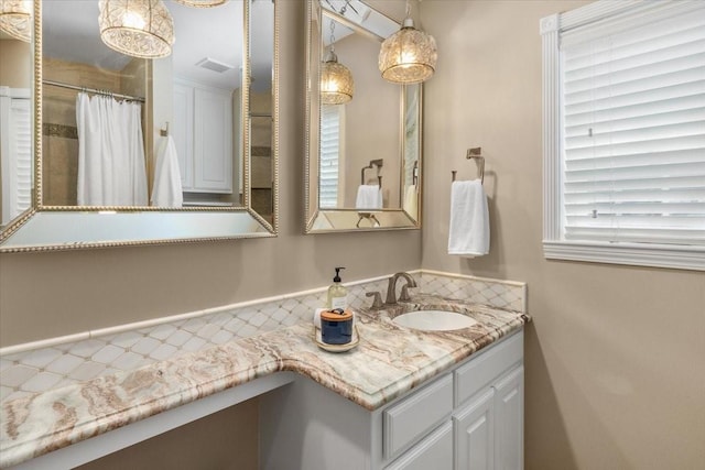 full bath featuring vanity and curtained shower