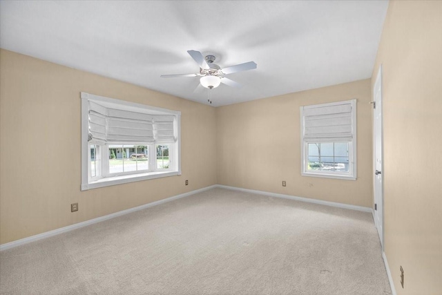 unfurnished room featuring carpet, ceiling fan, and baseboards