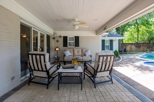view of patio with outdoor lounge area, fence, and a ceiling fan