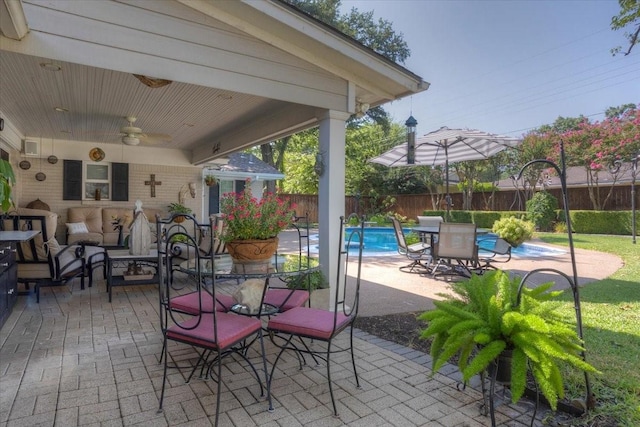 view of patio with fence, an outdoor hangout area, and ceiling fan