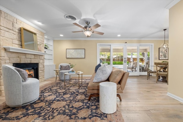 living area featuring baseboards, ceiling fan, ornamental molding, wood finished floors, and french doors