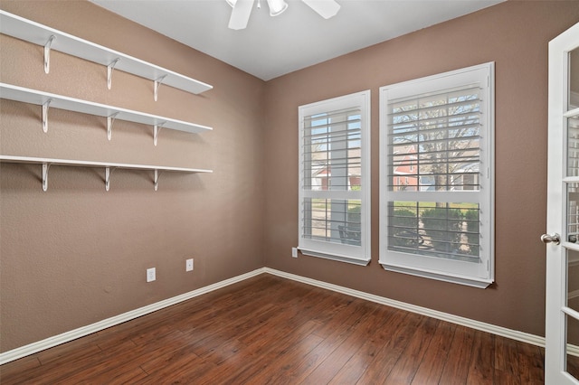 unfurnished room with hardwood / wood-style floors, ceiling fan, and baseboards