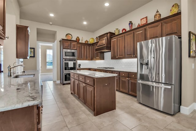 kitchen with tasteful backsplash, light stone counters, a sink, and stainless steel appliances