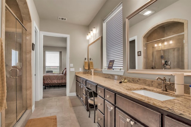 bathroom featuring a sink, visible vents, tile patterned floors, and a shower stall