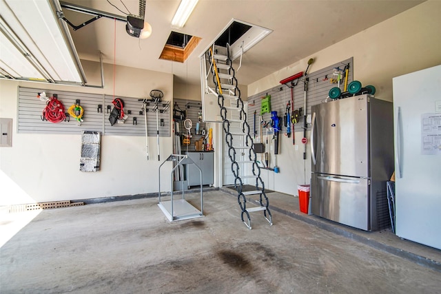 garage featuring a garage door opener and freestanding refrigerator