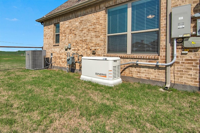 exterior details featuring brick siding, a power unit, and central AC unit