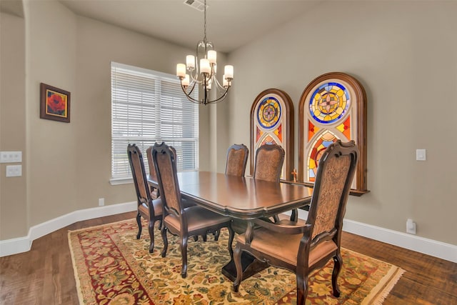 dining room with a chandelier, baseboards, dark wood-style floors, and visible vents
