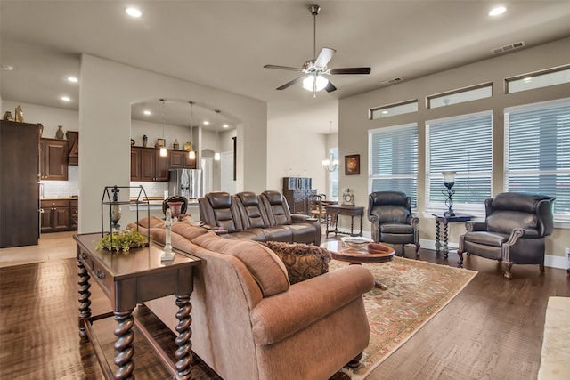 living room with ceiling fan, arched walkways, visible vents, recessed lighting, and wood finished floors