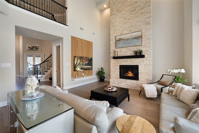 801 Ivy Glen Ct, Prosper, TX 75078 - living area with dark wood finished floors, a towering ceiling, and baseboards