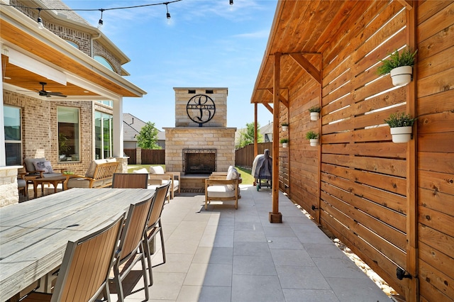 801 Ivy Glen Ct, Prosper, TX 75078 - view of patio / terrace featuring fence, an outdoor stone fireplace, and a ceiling fan