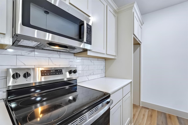 425 E Munson St, Denison, TX 75021 - kitchen featuring white cabinetry, light countertops, backsplash, and stainless steel appliances