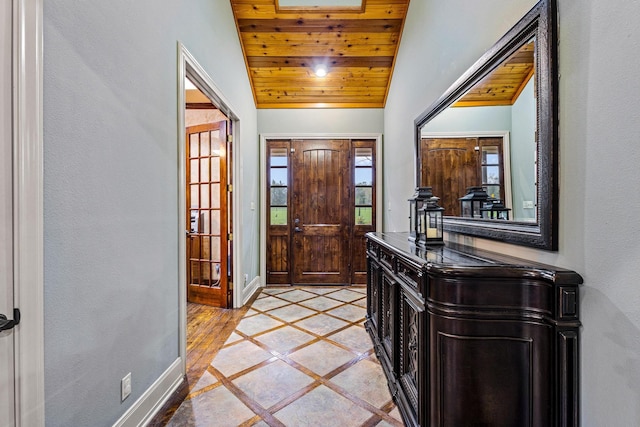entrance foyer with baseboards, wooden ceiling, and vaulted ceiling