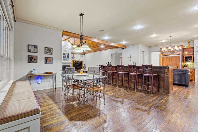 dining area with dark wood-style floors, a large fireplace, ornamental molding, and beam ceiling