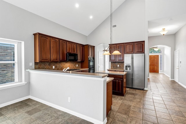 2309 Watercrest Dr, Keller, TX 76248 - kitchen featuring black appliances, arched walkways, high vaulted ceiling, tasteful backsplash, and baseboards