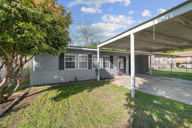 ranch-style house with a front yard, brick siding, and fence