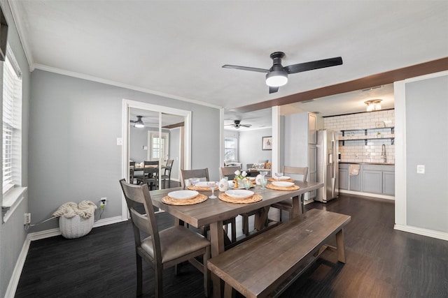 dining room with baseboards, ornamental molding, ceiling fan, and dark wood-style flooring