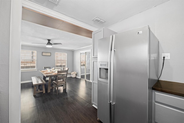 kitchen featuring dark wood-type flooring, a ceiling fan, visible vents, stainless steel refrigerator with ice dispenser, and baseboards