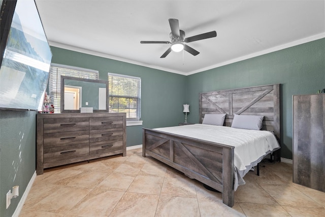 bedroom featuring baseboards, ornamental molding, and a ceiling fan