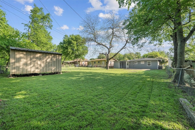 view of yard with a fenced backyard and an outdoor structure