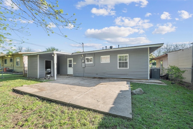back of property featuring a lawn, fence, a patio, and central AC unit