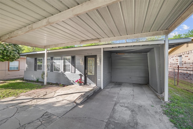 exterior space featuring fence and a carport