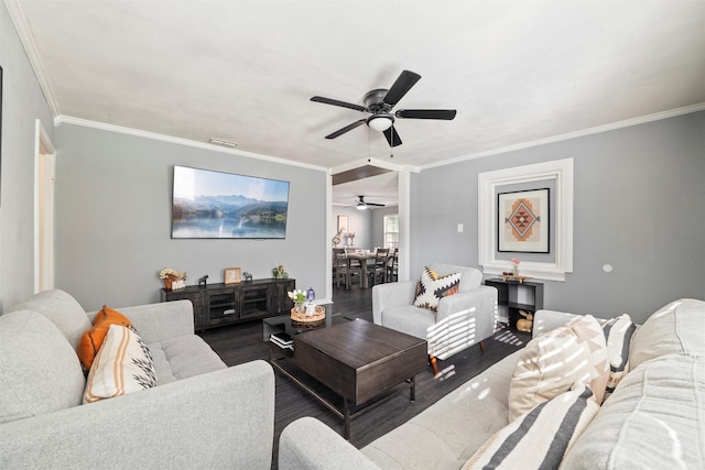 living room featuring wood finished floors, ceiling fan, crown molding, and visible vents