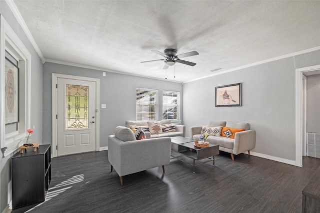 living room featuring visible vents, baseboards, dark wood-style flooring, ornamental molding, and a ceiling fan