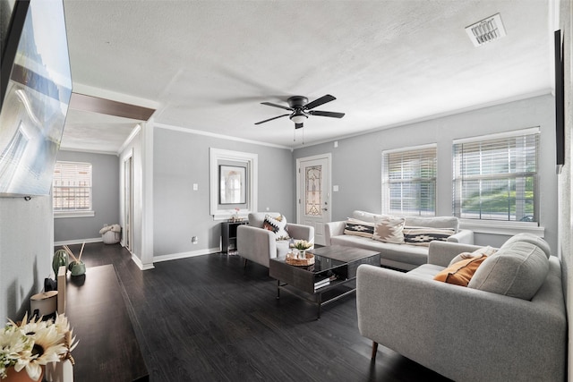 living area with visible vents, ceiling fan, dark wood finished floors, and baseboards