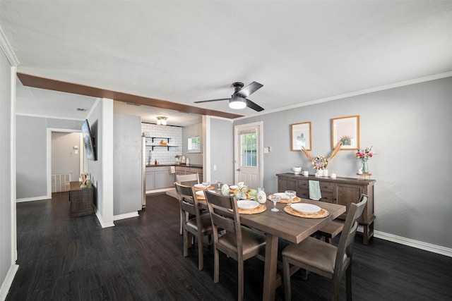 dining area featuring dark wood-style floors, a ceiling fan, visible vents, baseboards, and ornamental molding