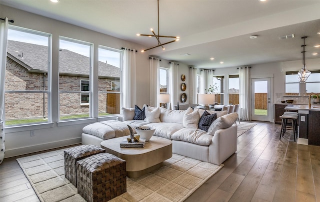 living area with visible vents, recessed lighting, a chandelier, baseboards, and hardwood / wood-style flooring